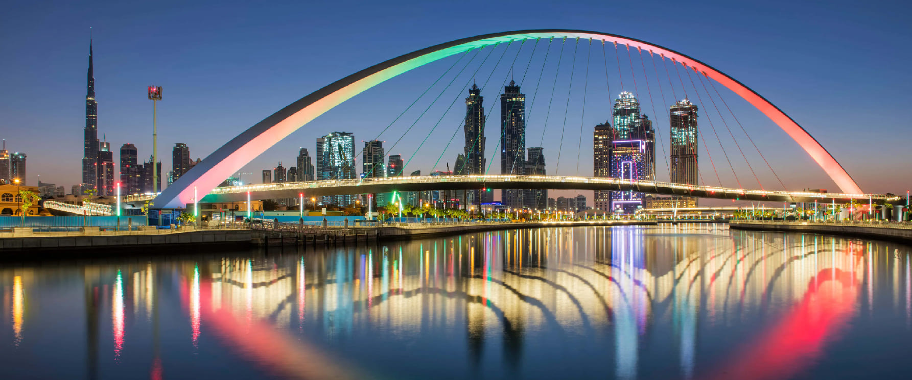 Dubai Water Canal free pedestrian bridges waterfall and skyline promenade