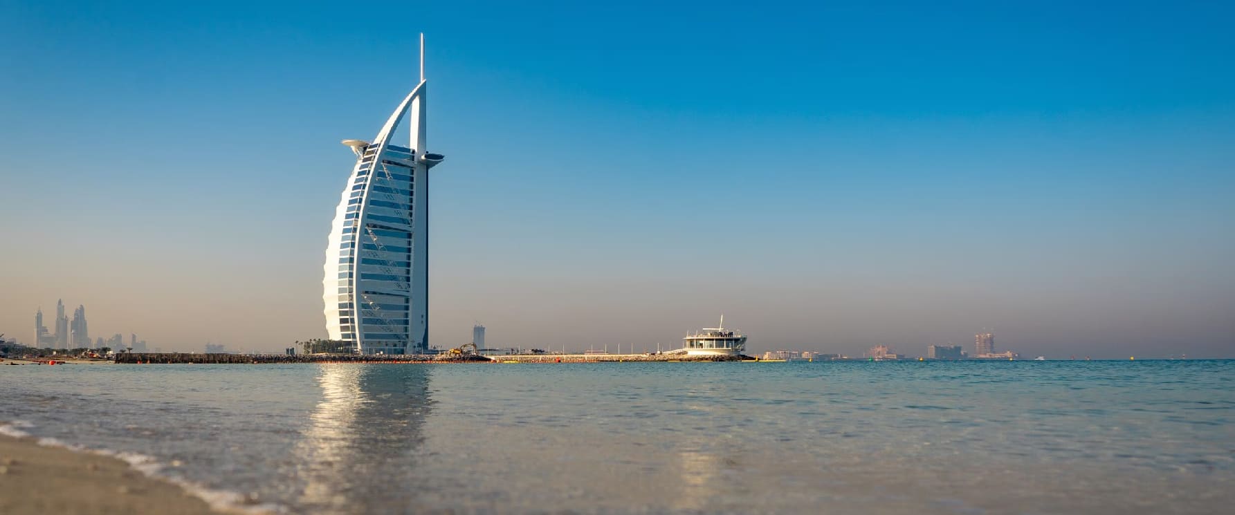 Umm Suqeim Beach free night swimming zone and sunset views near Burj Al Arab Dubai