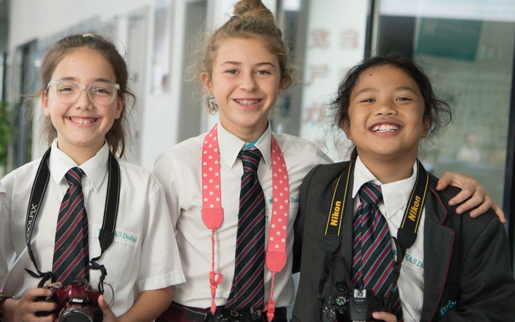 Students in a Dubai private school smiling after class