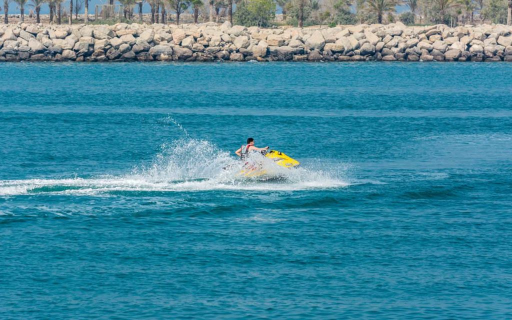 Jet skiing at Moon Island Dubai with turquoise Arabian Gulf water