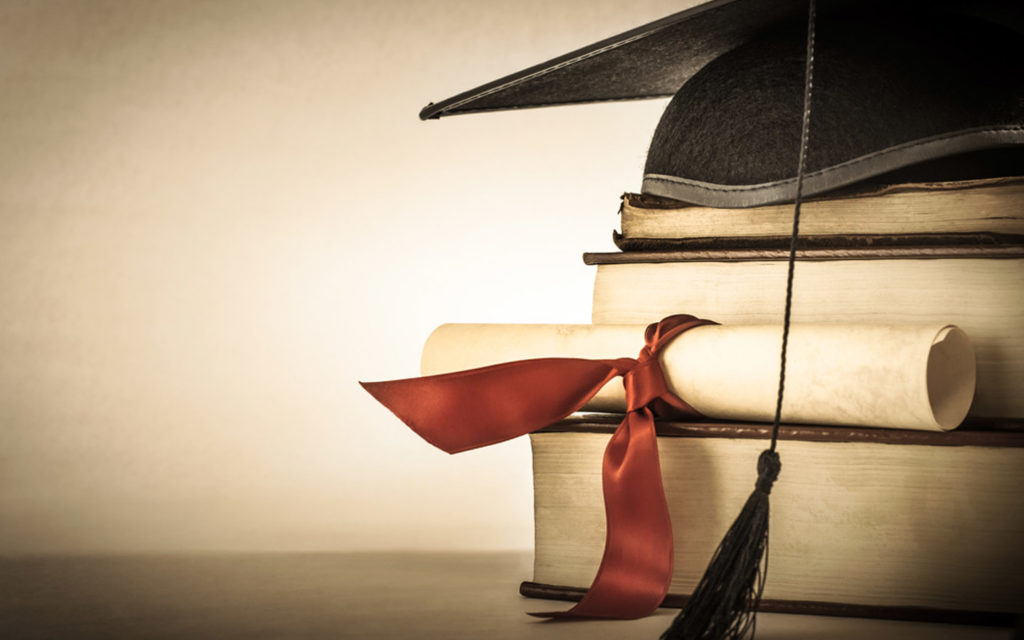 MOE-approved degree equivalency and graduation cap on books in the UAE