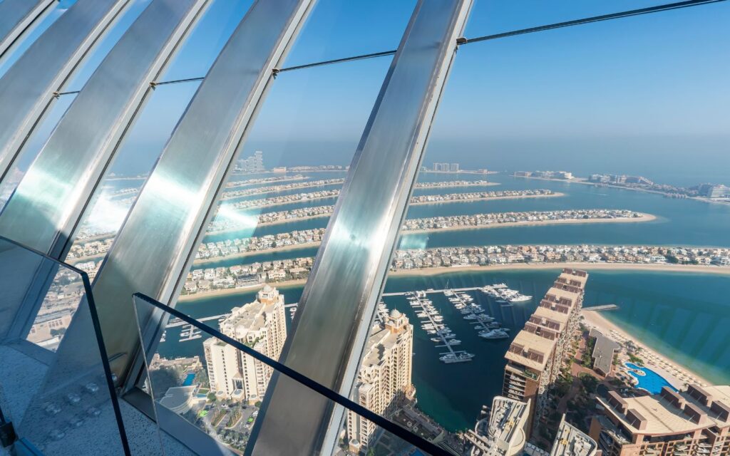 Wide panorama of Dubai skyline and Palm Jumeirah from The View at The Palm