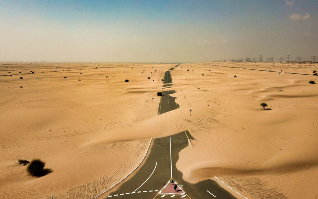 desert sand drifting over a Dubai highway after a storm