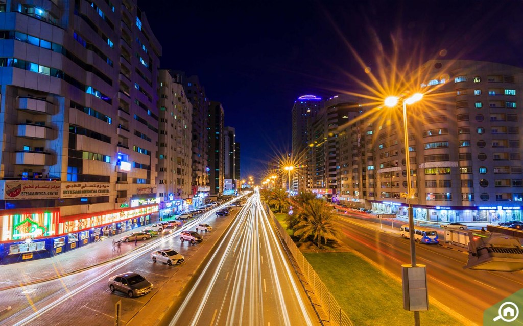 night street scene in Al Rashidiya Ajman with illuminated residential buildings