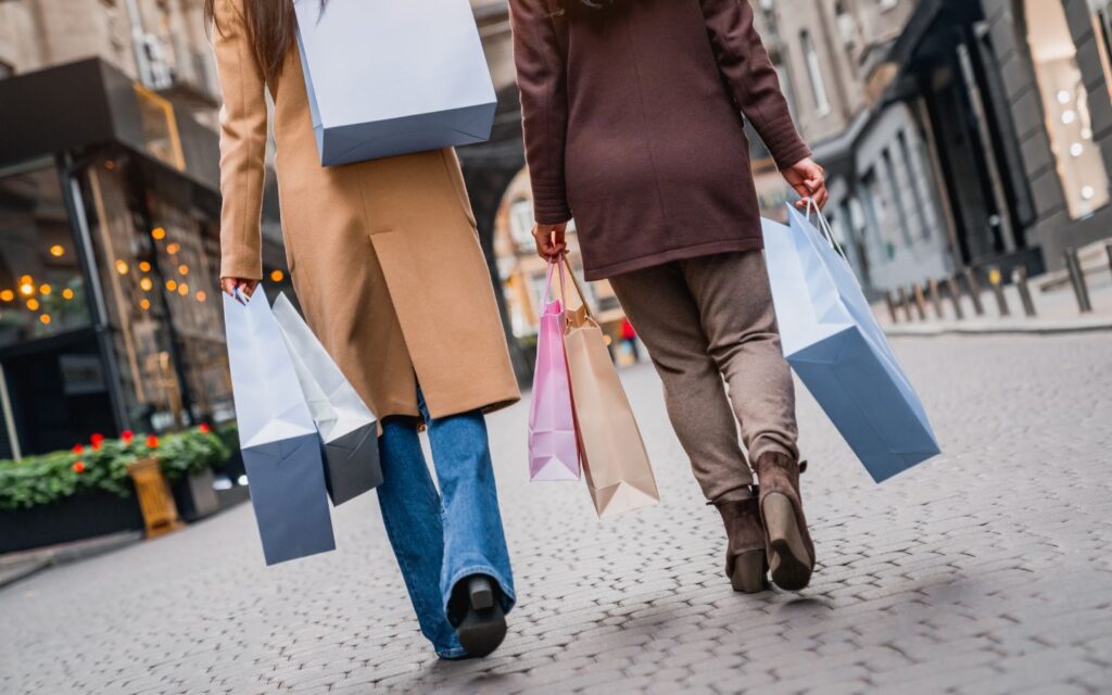 happy shopper holding multiple packages during abu dhabi online sales