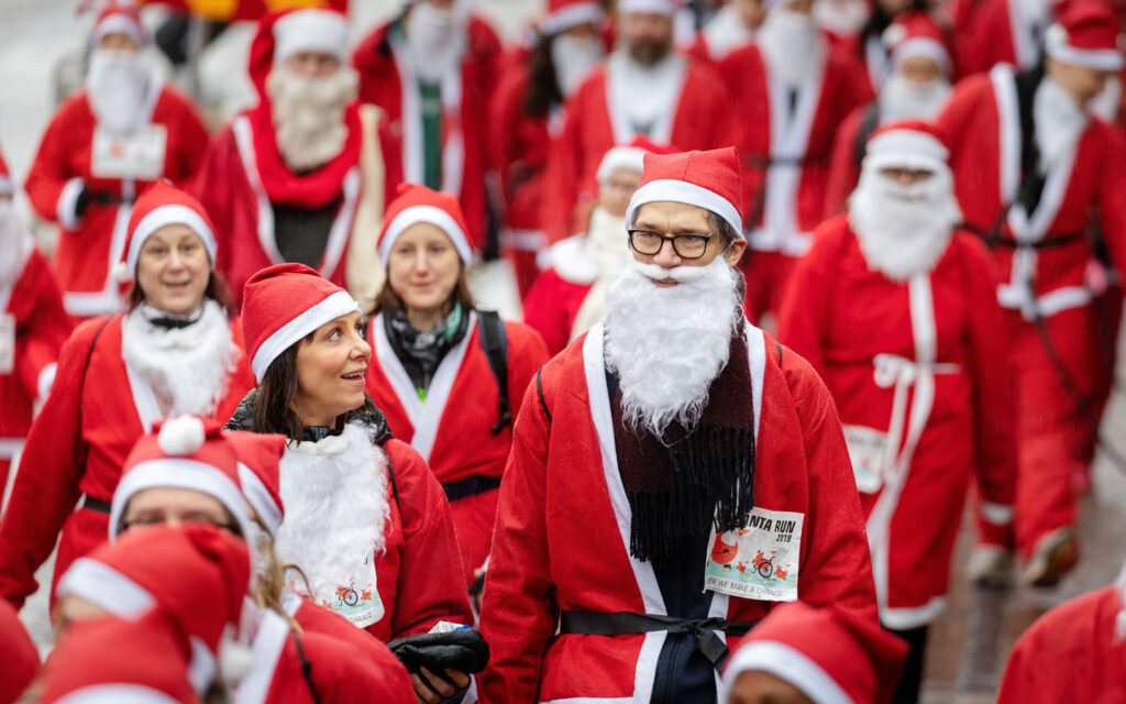 Runners in Santa outfits at Dubai Santa Run 2025 on Palm West Beach
