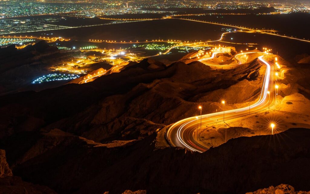 Panoramic road winding around Jebel Hafeet mountain in Al Ain