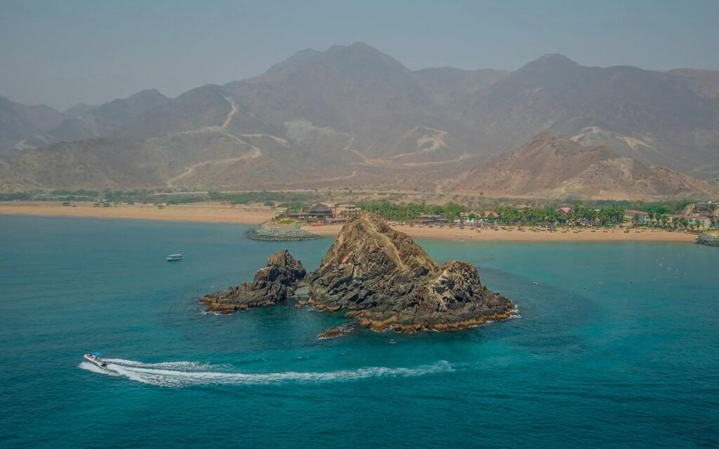 Snoopy Island in Fujairah with turquoise waters and mountain backdrop