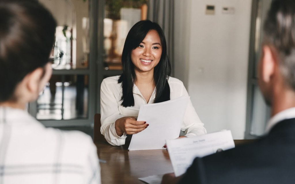candidate handing resume to recruiters at a walk-in interview in Dubai