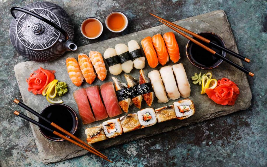 assorted sushi and sashimi platter with chopsticks at a Japanese restaurant in Deira