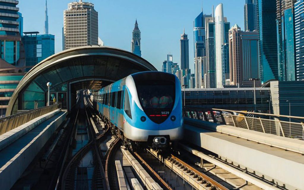 Dubai Metro train on elevated track with skyline