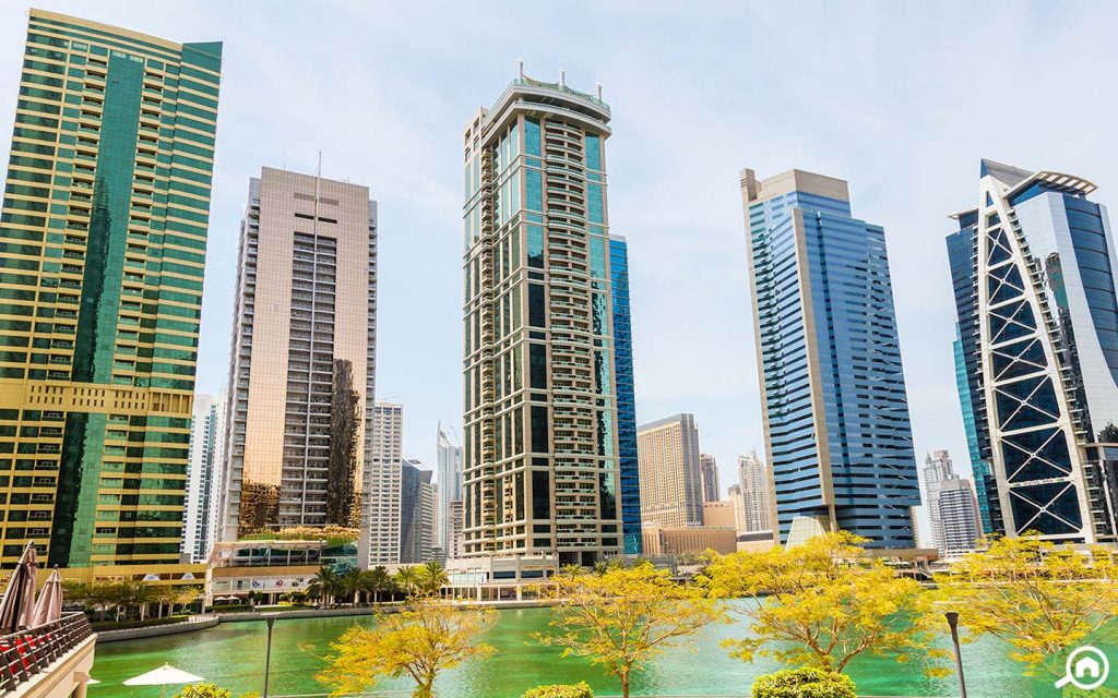 Apartment towers beside the lake at JLT, a Dubai district cooling area served by Empower
