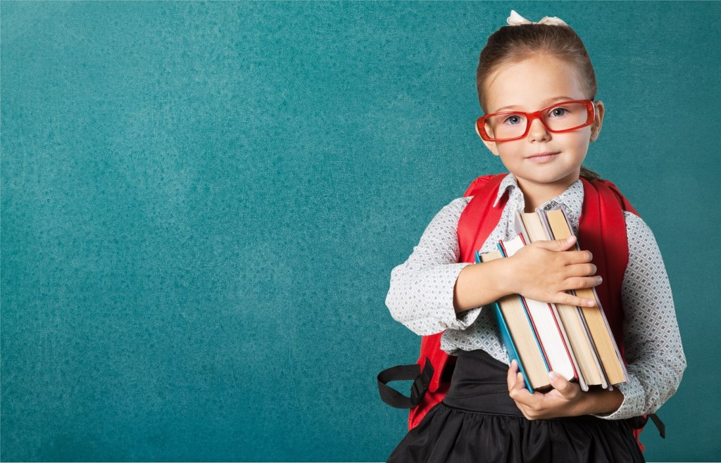school girl holding books at a Pakistani curriculum school in Ajman