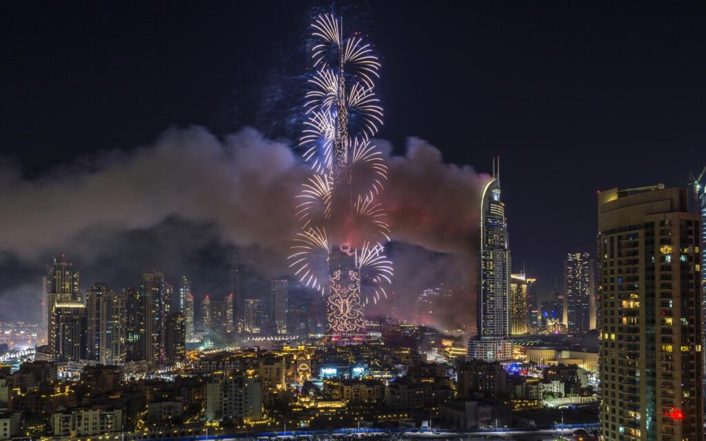 crowds watching Dubai New Year's Eve fireworks near Burj Khalifa